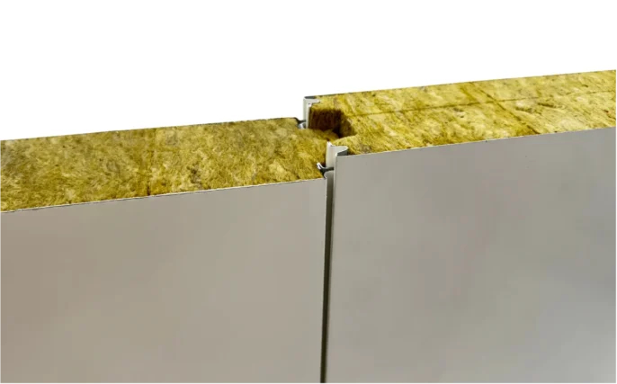 Vue en coupe de panneaux sandwich isothermes Dagard en laine de roche avec parements acier et bouvetage mâle-femelle pour isolation thermique et sécurité incendie - ISOSELL