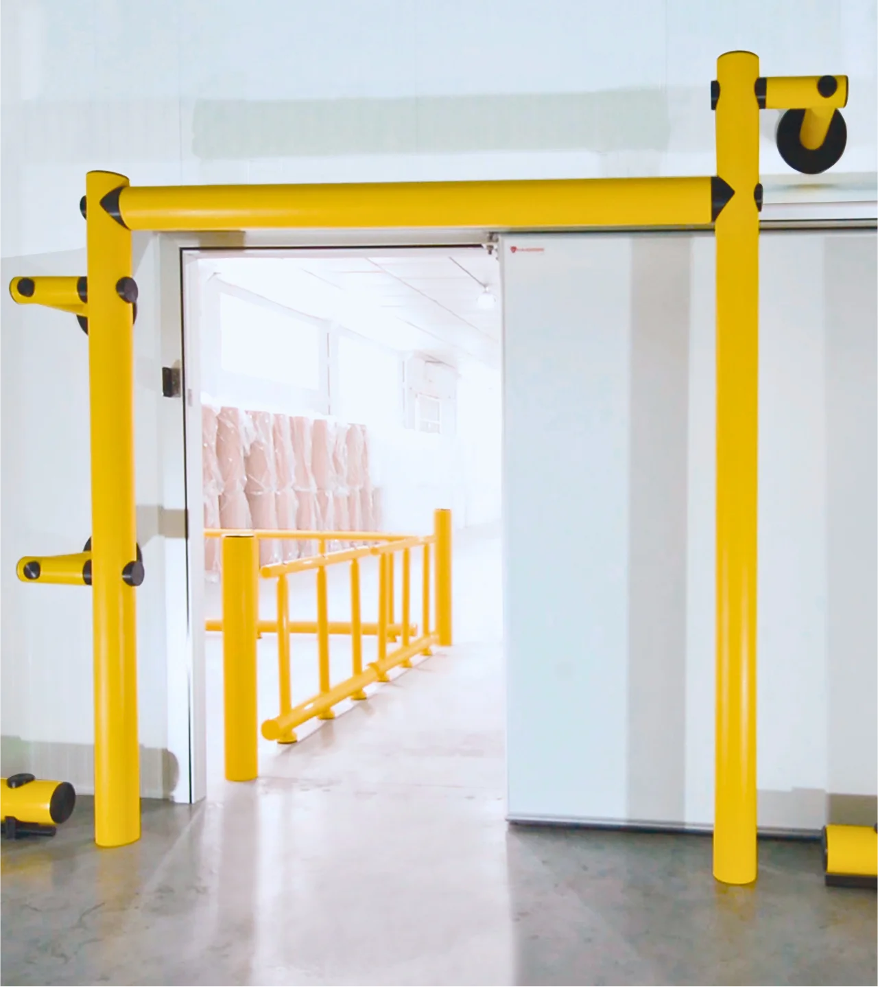 Protection jaune industrielle Panelchok installée autour d’un accès de chambre froide pour limiter les chocs sur les portes et panneaux ISOSELL